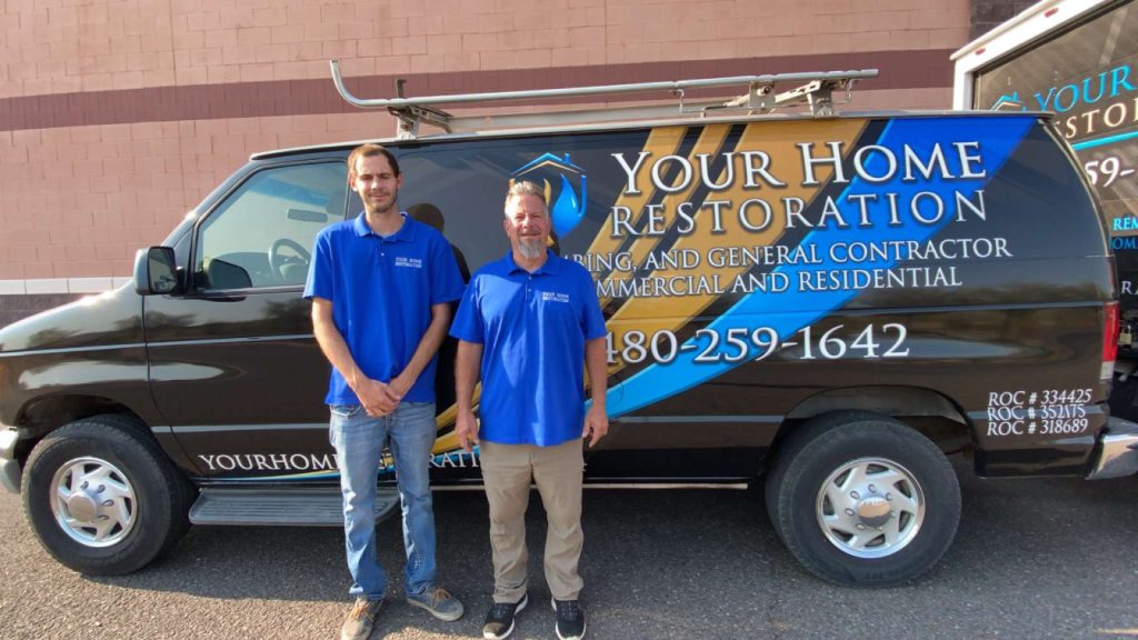employees in front of home restoration van
